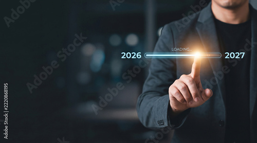 Businessman touching progress bar loading the year 2027 from 2026, concept of new year transition and future planning