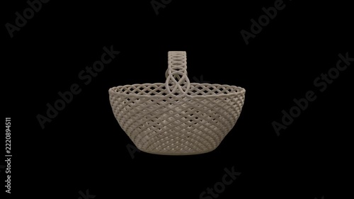 Slowly rotating woven wicker basket with handle against black background