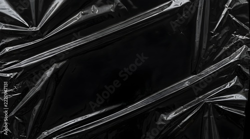 Abstract black plastic wrap texture background with wrinkled cellophane mockup frame