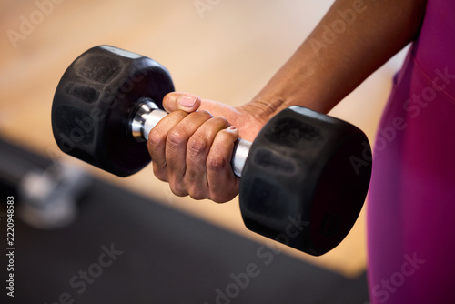 Hands gripping dumbbell