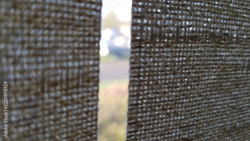 Close up of woven fabric curtain texture with light gap