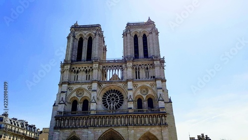 Exterior facade of Notre-Dame de Paris cathedral under clear blue sky