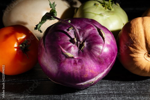 purple kohlrabi vegetable mix on black wood background