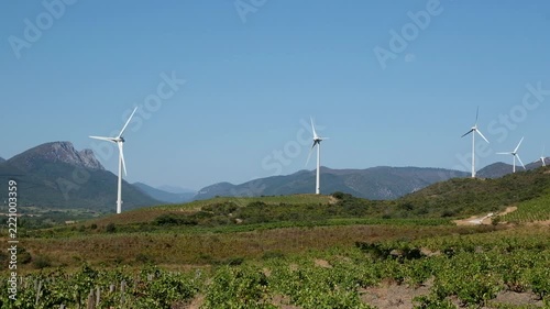 Beautiful landscape in the south of France with mountains, vineyards and wind turbines
