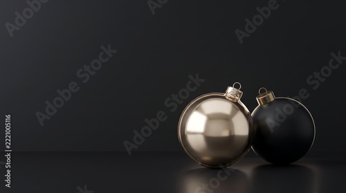 A premium Christmas still life featuring a reflective silver bauble and a matte black ornament arranged against a dark charcoal background.