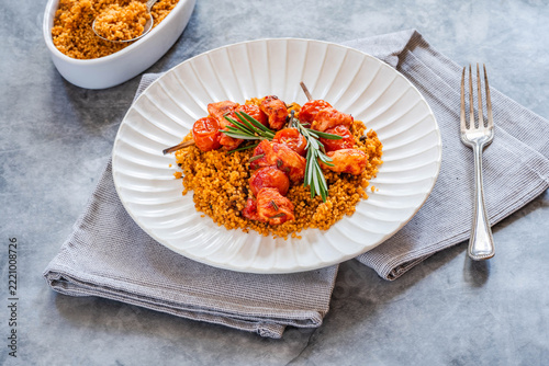 Spiced tomato and chicken skewers with mediterranean couscous