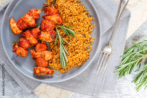 Spiced tomato and chicken skewers with mediterranean couscous