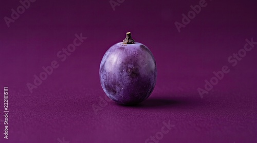 Grape sits in the center of a purple background.