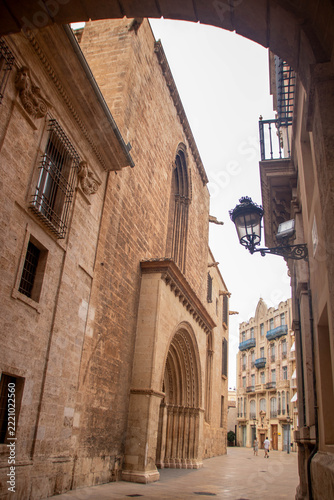 Historic stone archway and street view in Valencia, Spain