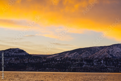  Winter sunset with snowy mountains over water 