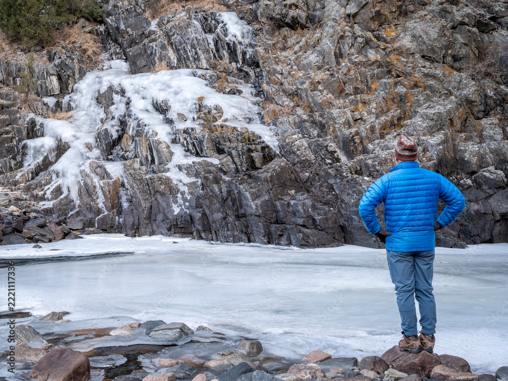 Naklejka premium male hiker in a canyon of mountain river in winter scenery - Poudre River at Little Narrow above Fort Collins, Colorado