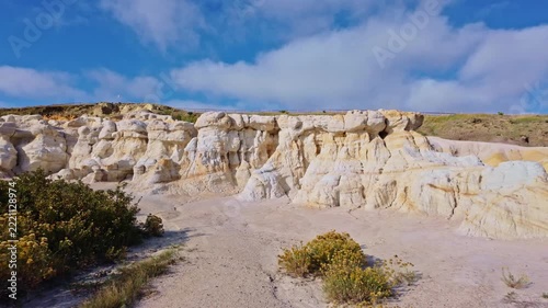Panoramic view captures colorful badlands and white rock formations along the trail in Paint Mines Interpretive Park