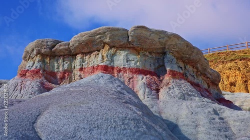 Colorful striped geological formations display vibrant clay layers in a close-up view at Paint Mines Interpretive Park