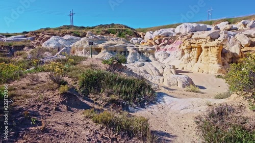 Vibrant pink and yellow geological formations rise at Paint Mines Interpretive Park in Calhan, Colorado