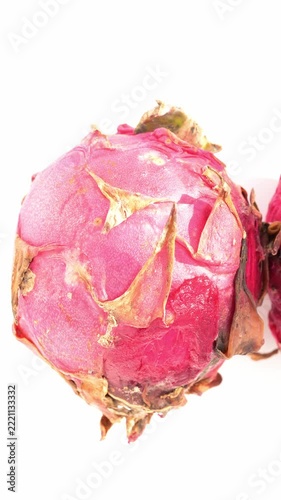 top pan three overripe and rotting pitayas showing mold and damaged flesh on white vertical composition
