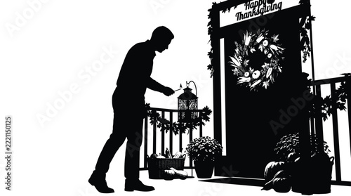 Black and white silhouette of man lighting decorative porch lantern for Thanksgiving holiday celebration
