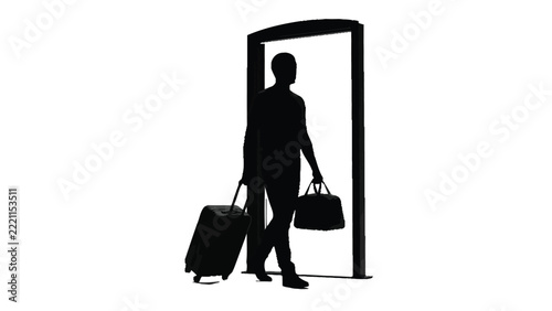 Dark silhouette of traveler walking through open doorway while pulling wheeled suitcase and holding bag
