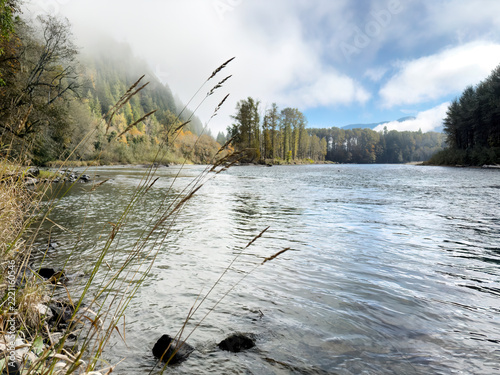 Morning with the fog clearing on the Skagit river in the Cascades of Washington state during a fishing day in mid fall season