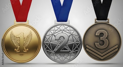 Gold silver and bronze medals hanging on colorful ribbons representing first second and third place victory sports achievements