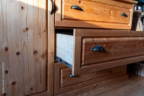 Hand made pine wood chest of drawers, one opened drawer.