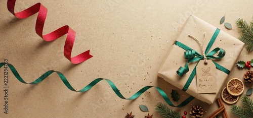 Festive Gift Box Wrapped in Kraft Paper with Red and Green Ribbons, Christmas Decorations.