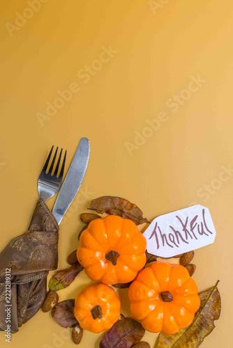 Thankful message with pumpkins and autumn cutlery