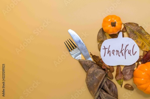 Thanksgiving dinner setting with thankful pumpkin sign