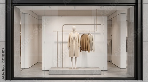 Fashion storefront window with clothing on minimalist rack.