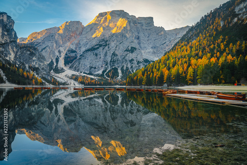 Sunrise reflection with alpine peaks on the Braies lake, Dolomites