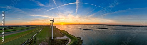 Wind turbines generating clean energy at sunset in Netherlands