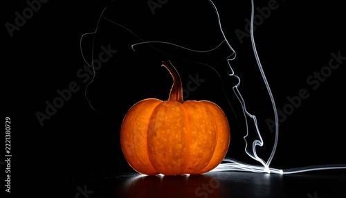 Pumpkin Illuminated by Light Painting on a Black Background