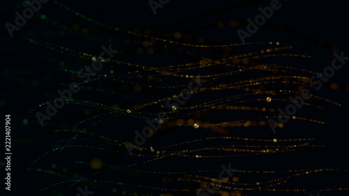 Emerald and gold swirling particle vortex with copy space