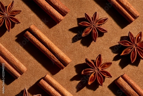 Cinnamon sticks and star anise arranged on tan background