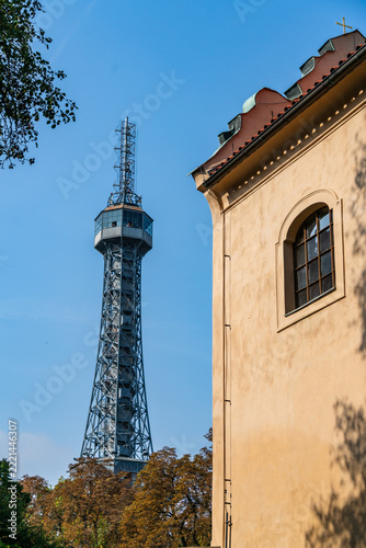 Petrin lookout tower rising above the historic architecture of Prague on a clear autumn day