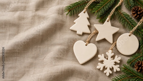 Festive Holiday Decorations with Pine Branches and Wooden Ornaments on Fabric