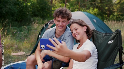 Family relaxing and spending time together at campsite.