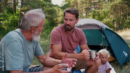 Family relaxing and spending time together at campsite.
