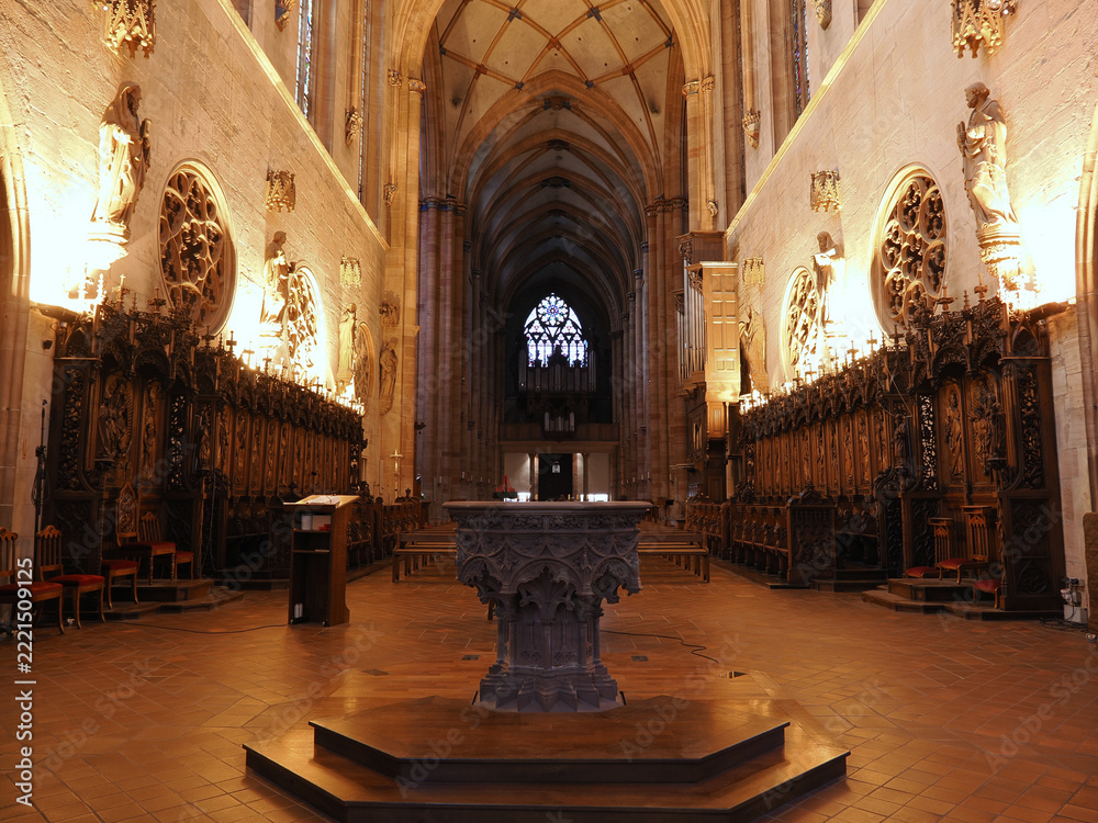 Obraz premium Interior view of Saint-Martin gothic cathedral nave featuring ribbed vaulting, wooden choir stalls, and ornate font. Colmar, Alsace, France