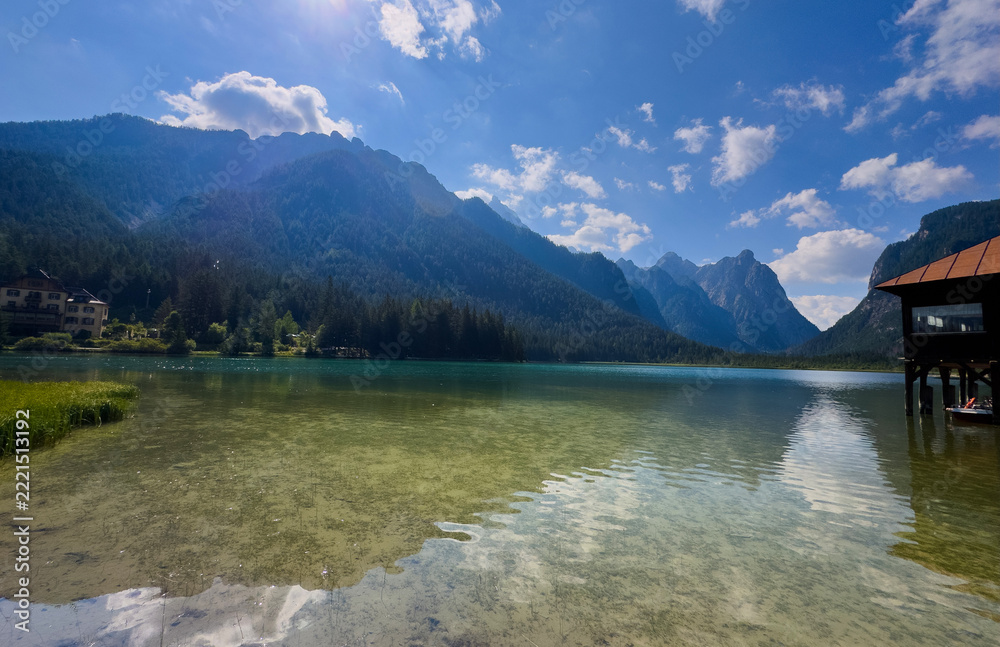 Fototapeta premium mountain in morning light reflected in calm waters of lake Dolomites Italy