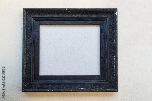 old black frame hanging on a wall