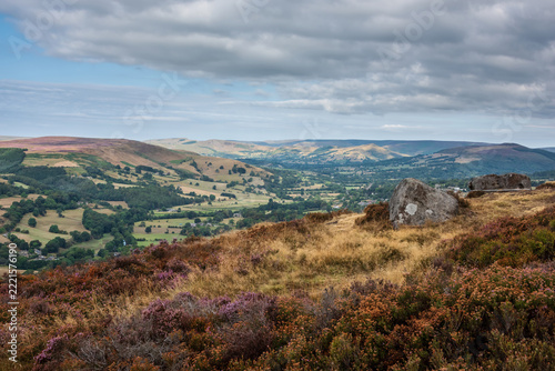 Stunning Peak District landscape from Surprise View with vibrant heather and dappled sunlight over the hills