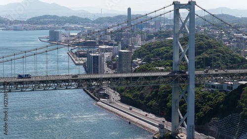 Aerial drone footage hovering over Kanmon Bridge spanning Kanmon Strait, Japan