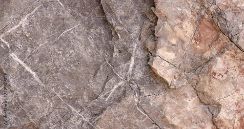 Cracked Gray and Rust Colored Rock Texture with White Mineral Veins and Slow Camera Movement