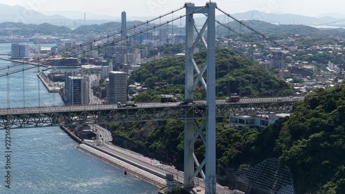 Aerial drone footage hovering over Kanmon Bridge and Kanmon Strait in Japan