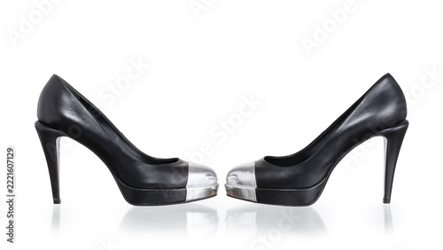 High-heeled pumps in black leather with a rigid silver cap_toe. Photographed on a white background.