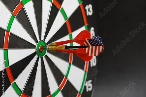 Precision and Focus: Dart Hitting Bullseye on Dartboard with American Flag Design