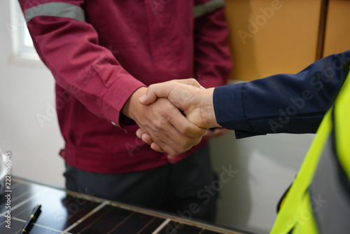 Handshake, worker, uniform, safety, agreement, cooperation during professional greeting at indoor counter