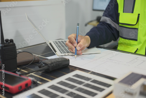 Worker, pencil, blueprint, laptop, planning, workstation with focused attention during indoor technical review