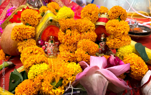 Hindu Idols of Lord Ganesha and Goddess Lakshmi Adorned with Marigold Garlands
