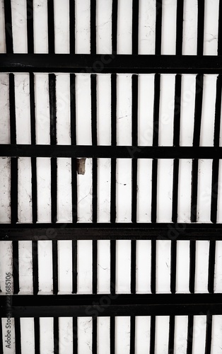 Abstract geometric pattern of black and white vertical lines and structural grid background texture